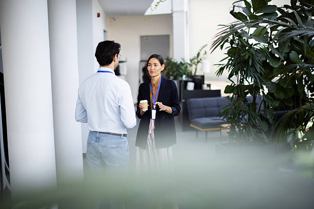 istock Business colleagues chatting during coffee break in modern office 2248808352