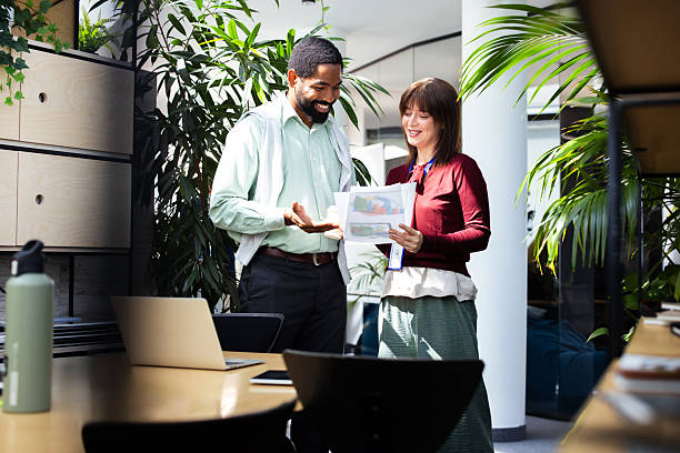 istock Business colleagues discussing charts in modern green office 2248808362