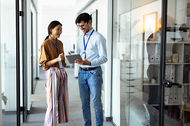 Business colleagues collaborating on digital tablet in modern office