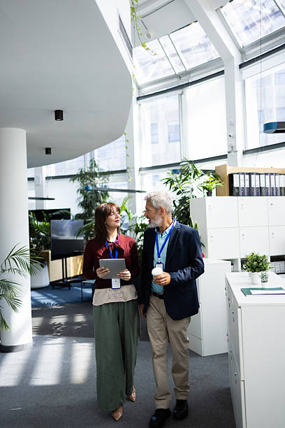 istock Business people walking and talking in modern office 2248808441