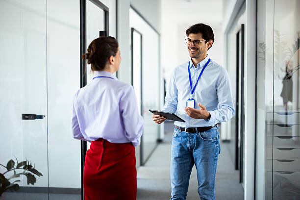 istock Business colleagues discussing work in modern office corridor 2248808584