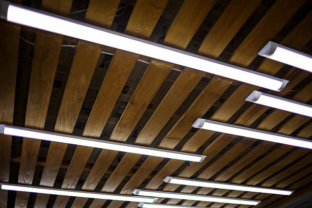 istock Wooden ceiling with long white lamps 2248815060