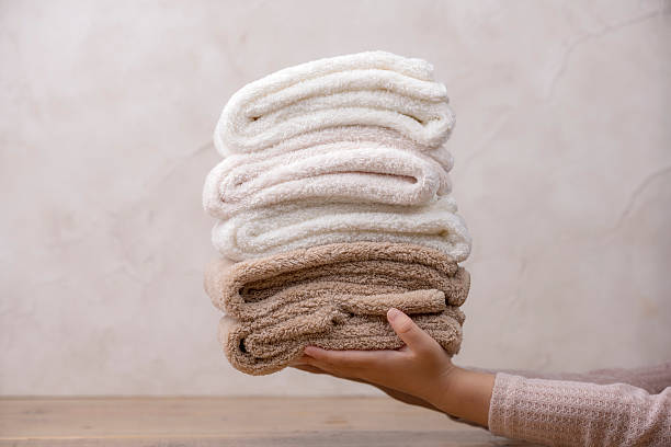istock Little Girl's Hand Holding a Stack of Soft Towels 2248815512