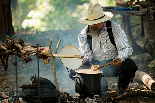 istock A cowboy preparing food at a rustic outdoor campfire 2248815560