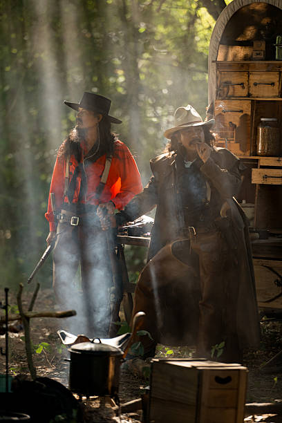 istock Two cowboys standing in their camp surrounded by smoke and sunlight 2248815905