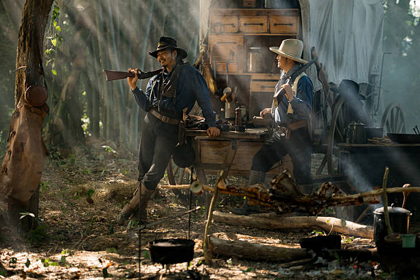 istock Two cowboys standing in their camp surrounded by smoke and sunlight 2248815916