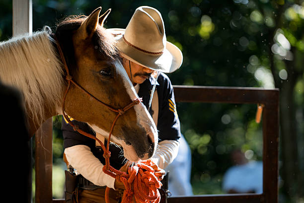 istock A cowboy standing beside his horse 2248816078