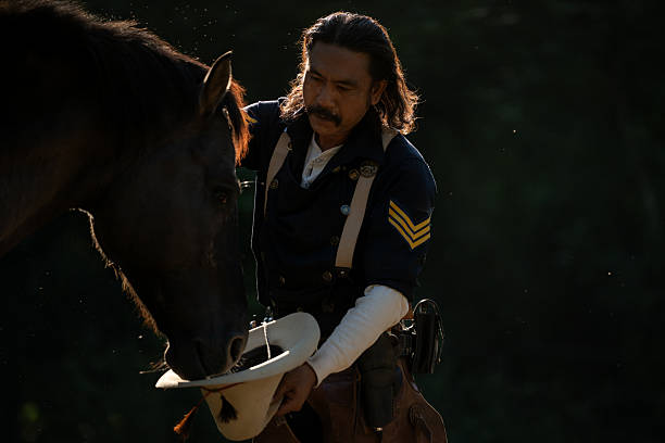 istock A cowboy gently touching his horse in warm evening light 2248816101