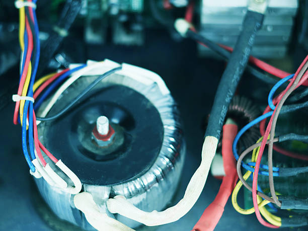 istock Close-up image showing a toroidal transformer and multi-colored wires. 2248816642