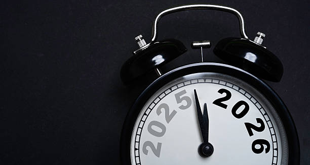 istock Alarm clock showing the transition from 2025 to 2026 symbolizing new year countdown future planning time management and goal setting on a dark background suitable for business and lifestyle themes 2248821125