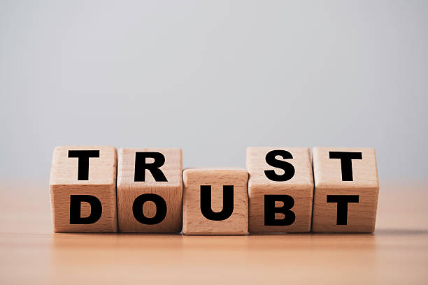 Wooden blocks flipping trust and doubt symbolizing decision making confidence uncertainty and human mindset on a clean minimalist background suitable for business leadership and psychology themes