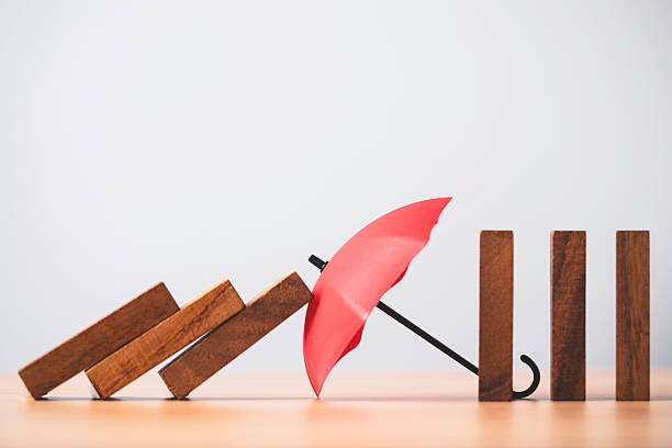 istock A red umbrella blocking falling wooden blocks symbolizing risk prevention protection safety support and stability on a clean minimalist background suitable for business insurance and risk management 2248824261