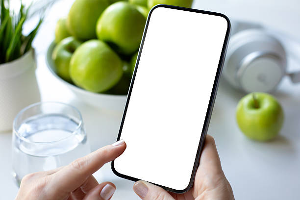 istock Female hands holding phone with isolated screen background green apples 2248824984