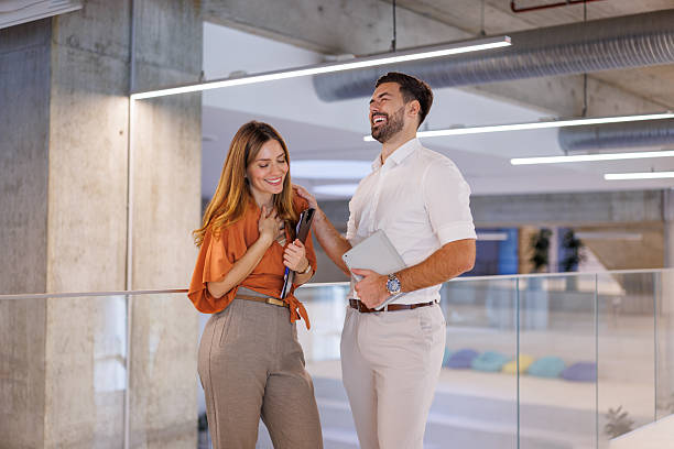 istock Business colleagues laughing and conversing in modern office 2248827154