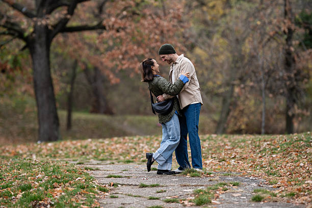 istock Loving couple embracing in autumn park pathway 2248828040