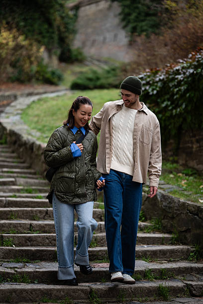 istock Happy couple walking down park stairs holding hands 2248828393