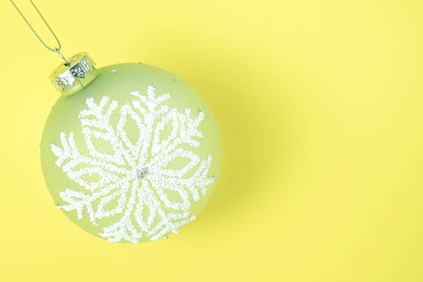 istock Yellow background with ball-shaped ornaments, Christmas background 2248828549