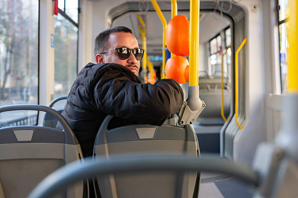 istock Man in sunglasses riding public transport looking back 2248829343