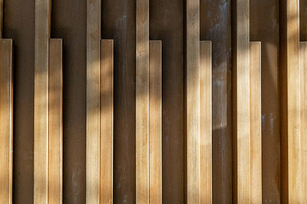 Abstract vertical wooden panels with shadows and light patterns.