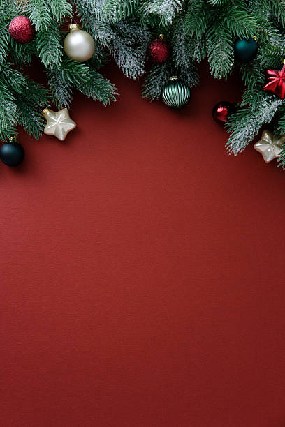 istock Christmas garland border on a rich red background with copy space. Top view, vertical. 2248830245