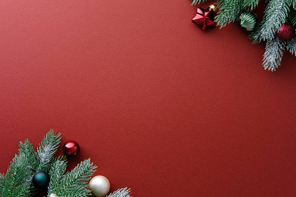 istock Minimalist Christmas decorations in opposite corners on a rich red background 2248830291