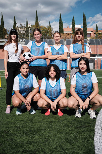 istock Women soccer team posing on field with coach 2248830356