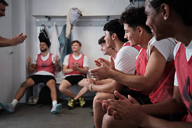 istock Soccer team celebrating victory clapping in locker room 2248830396