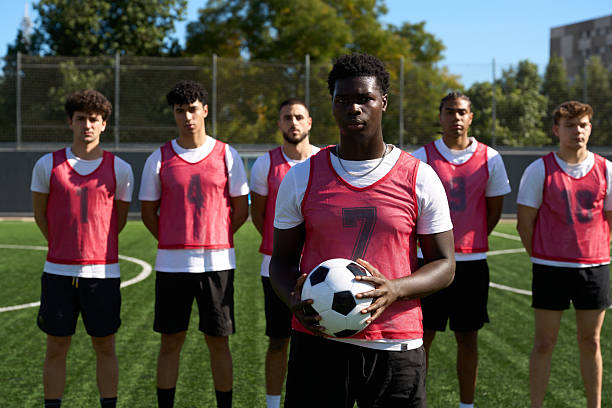 istock Soccer team standing on field with ball preparing for match 2248830532