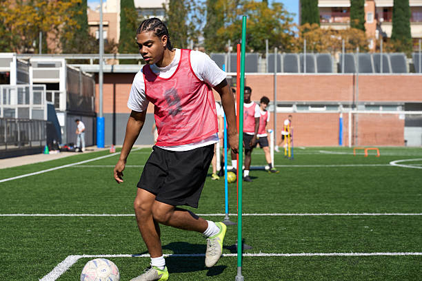 istock Young man training soccer dribbling on a field 2248830577