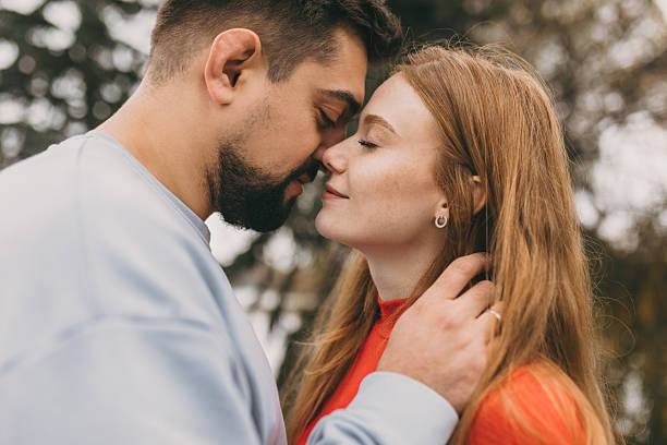 istock lips touch anniversary, two partners gently hold each other as they enjoy their anniversary outdoors 2248830589