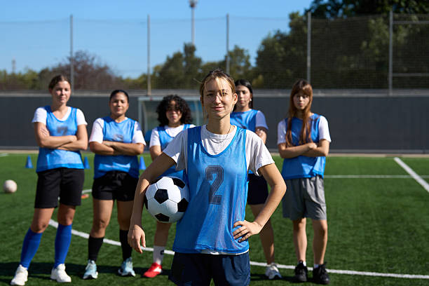 istock Female soccer team posing on field with ball 2248830622