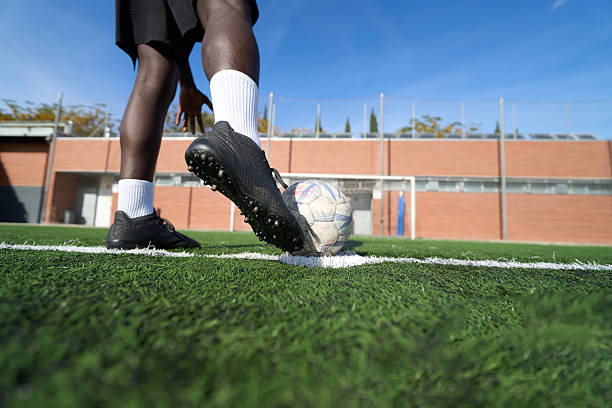 istock Black man's foot on soccer ball for corner kick 2248830718