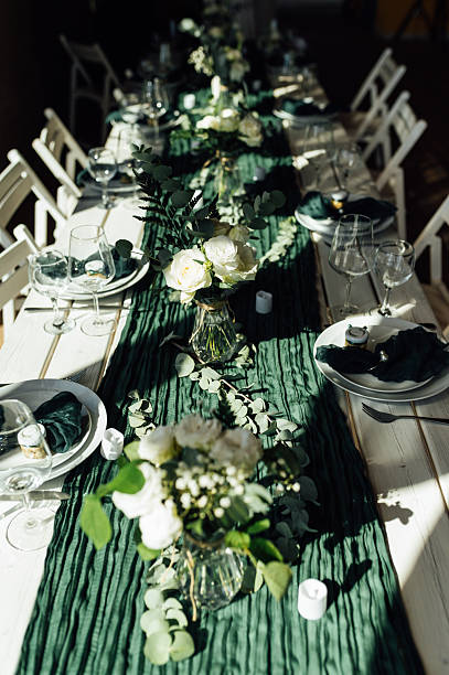 istock Elegant festive table setting with green decor and glassware 2248830720