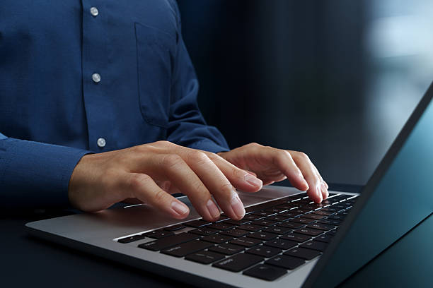 istock Businessperson using laptop computer at desk in office. 2248831577