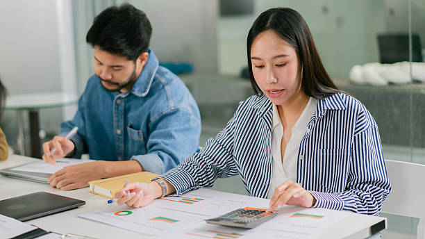 istock woman analyzing data with calculator in modern office setting Leader Teamwork stratup 2248832967