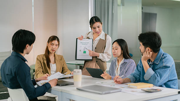 istock team meeting in modern office setting, discussing solutions with presentation. atmosphere is collaborative and focused. Leader Teamwork stratup 2248832974