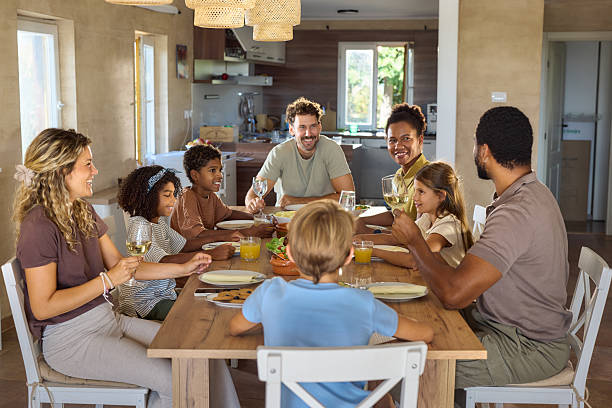 istock Happy diverse families talking during lunch at dining table. 2248833314