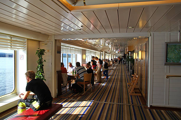 Dunkerque, France - July 07, 2025: Modern ferry lounge with purple seating, colorful mural and cozy ambiance for passengers
