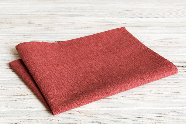 istock top view with red empty kitchen napkin isolated on table background. Folded cloth for mockup with copy space, Flat lay. Minimal style 2248834538