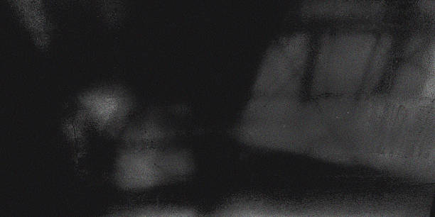 istock Abstract black and white background texture resembling blurred frosted glass with heavy digital noise, grain, and subtle light leaks, creating dark, atmospheric, and grainy pattern 2248837091