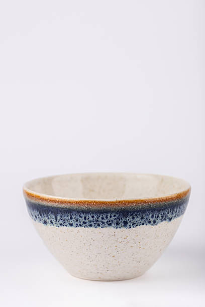 istock White ceramic bowl with blue and brown rim, handcrafted and minimalist design, vertical image with copy space. Concept of modern kitchen and natural lifestyle 2248837227