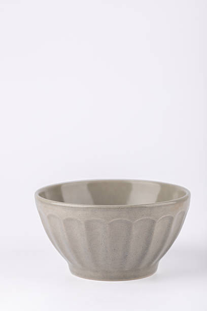 istock Gray ceramic bowl with relief texture, minimalist and simple design, vertical image with copy space. Concept of contemporary design and slow living 2248837228