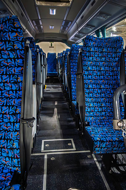istock Empty interior of a modern coach bus with rows of blue patterned seats and safety belts, highlighting efficient public transportation and comfortable travel. 2248837284