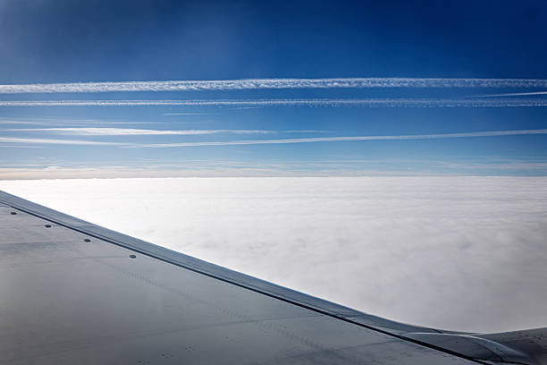 Contrails over the English Channel, a location with a very high concentration of air traffic. The wing in the foreground belongs to a Boeing 737-800.