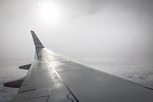 Winglet and sun in hazy light during approach to Gatwick Airport outside London. The wing belongs to a Boeing 737‑800.