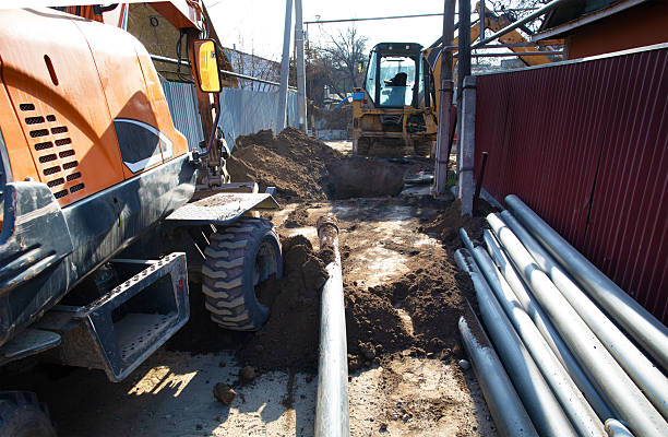 istock An excavator digs a hole for sewer pipes 2248838751