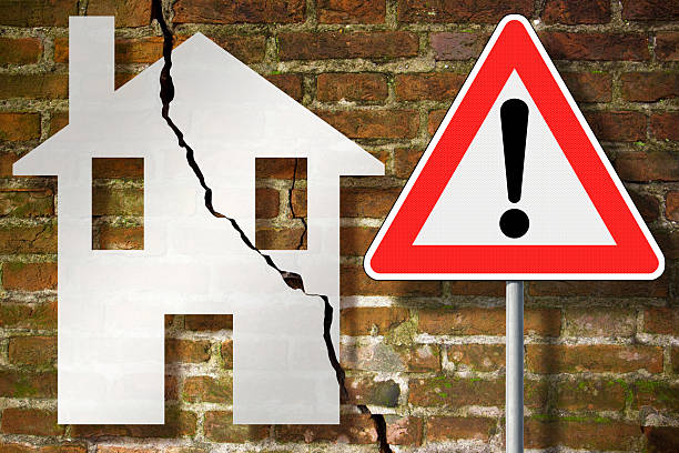 istock DANGEROUS OLD EXPOSED CRACKED BRICK WALL due to structural foundation failure, soil subsidence, earthquake, corrosion or deterioration of building materials - Concept with danger sign 2248838809