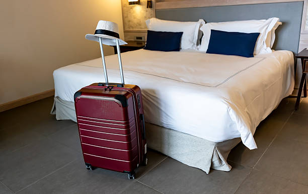 Travel suitcase and hat in a hotel room