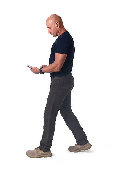 istock side view of walking man looking at her mobile phone on white background 2248840260