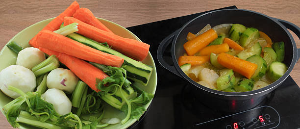 Mixed vegetable stew without meat, simmering in a casserole dish. Ingredients: raw vegetables
